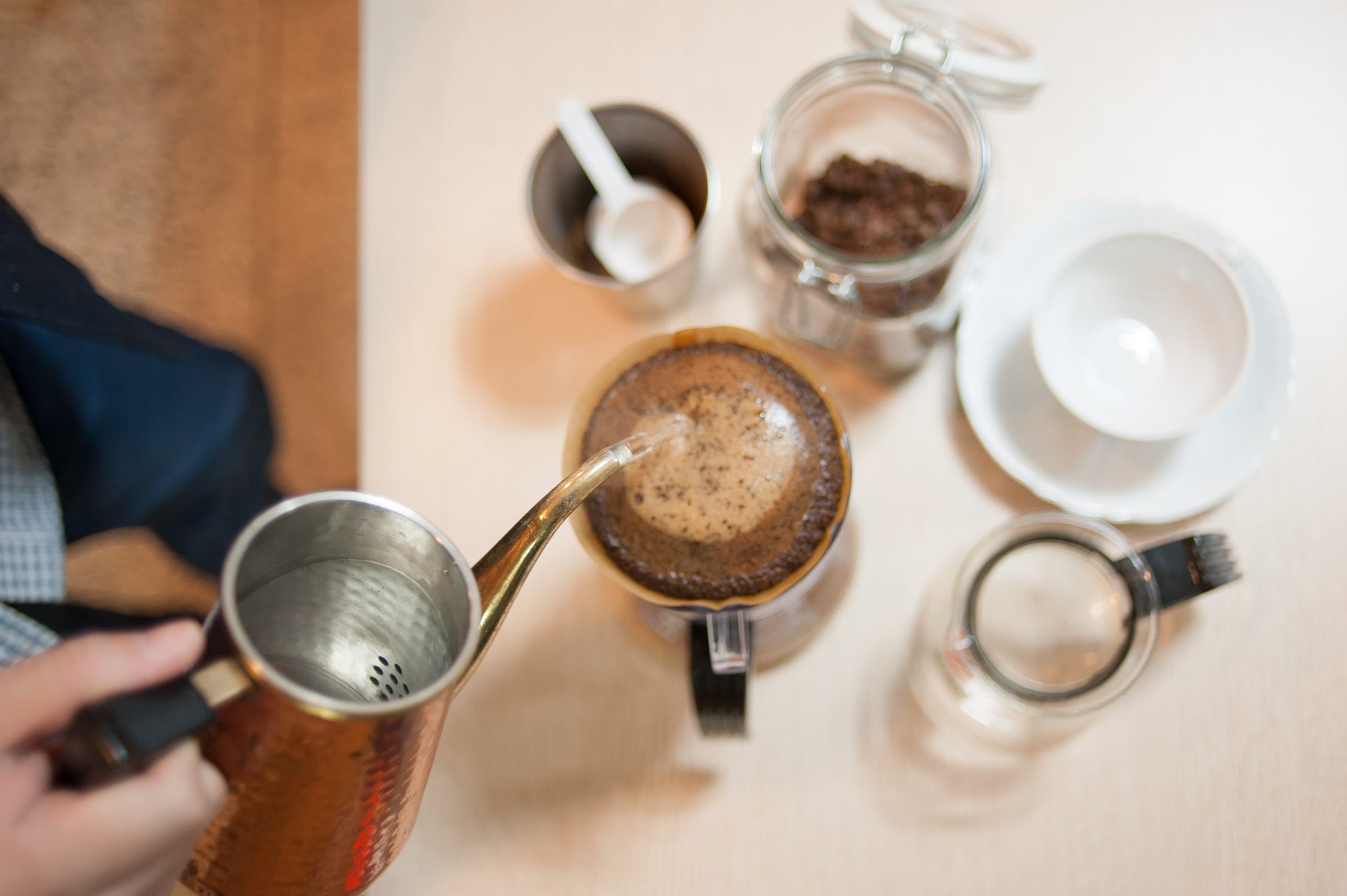 Water poured over a paper filter cone in a manual pour-over brew.